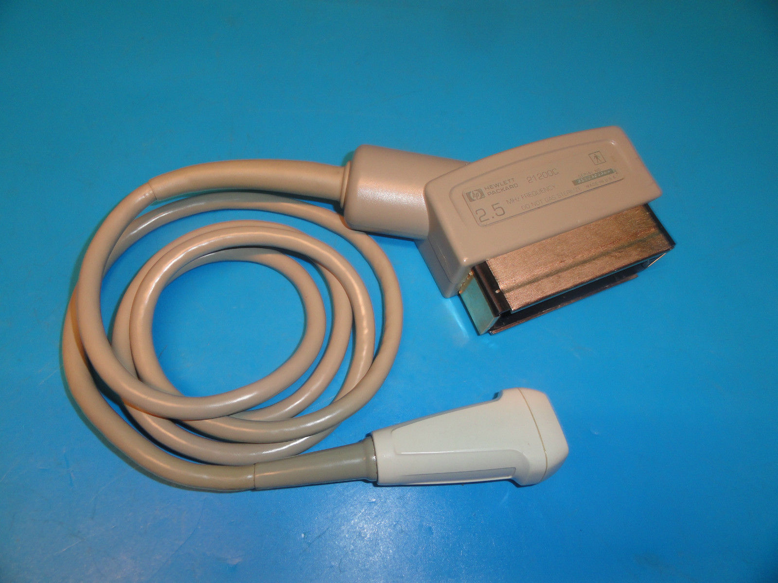 a cord connected to a device on a blue surface