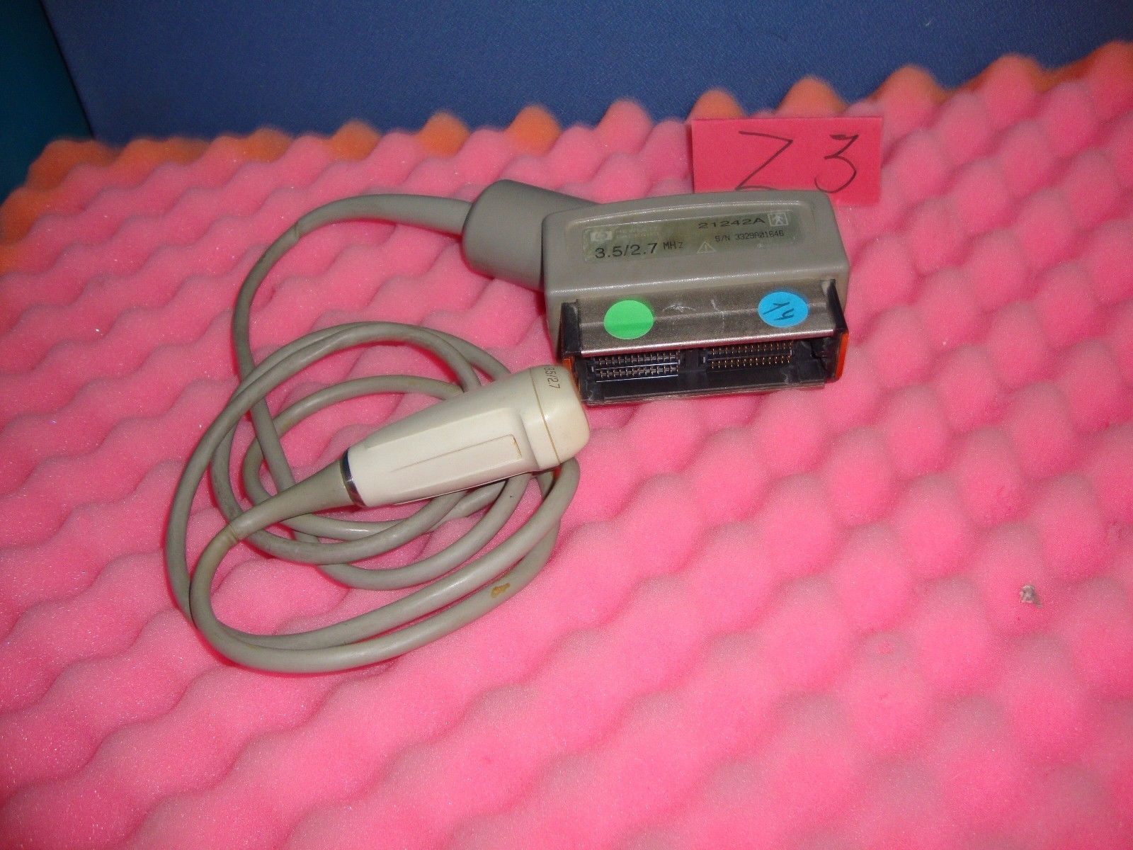 a cord connected to a device on top of a pink blanket