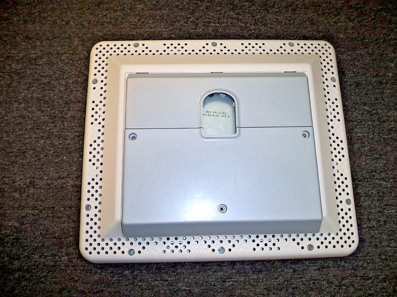 a white electronic device sitting on top of a carpet
