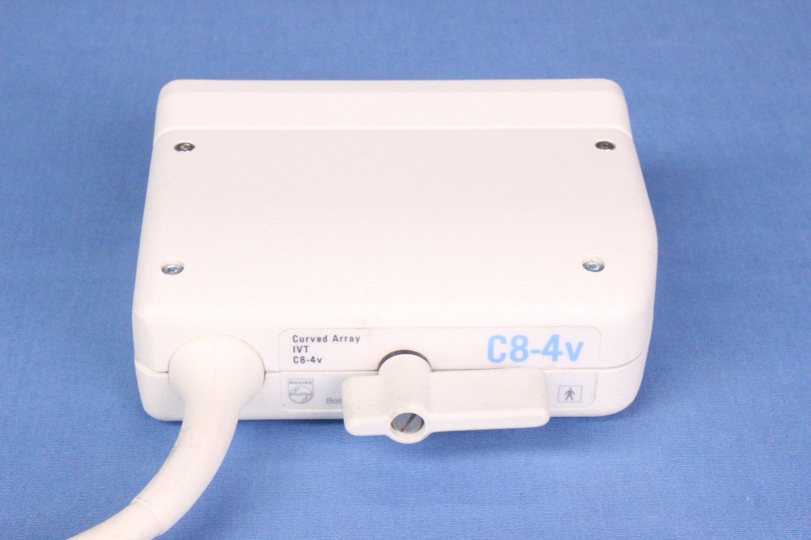 a close up of a white electronic probe on a blue background