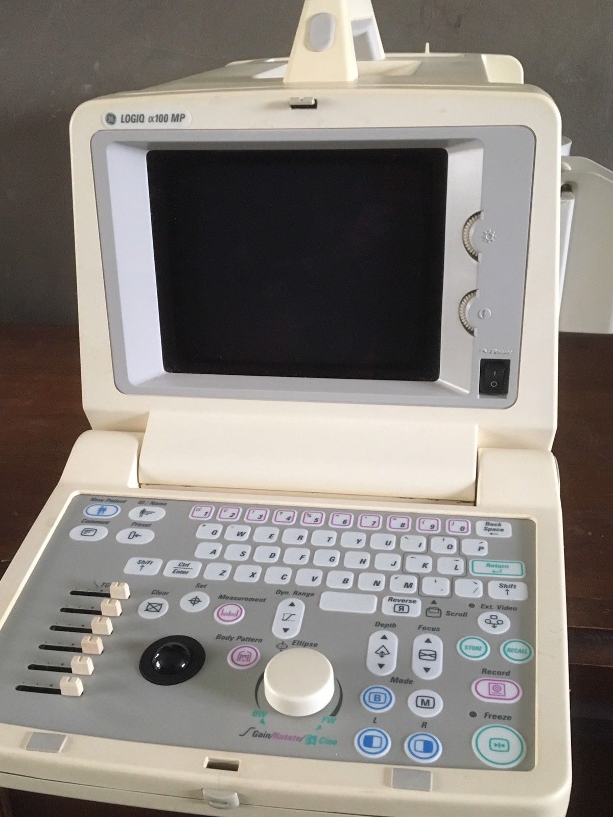 a medical device sitting on top of a wooden table