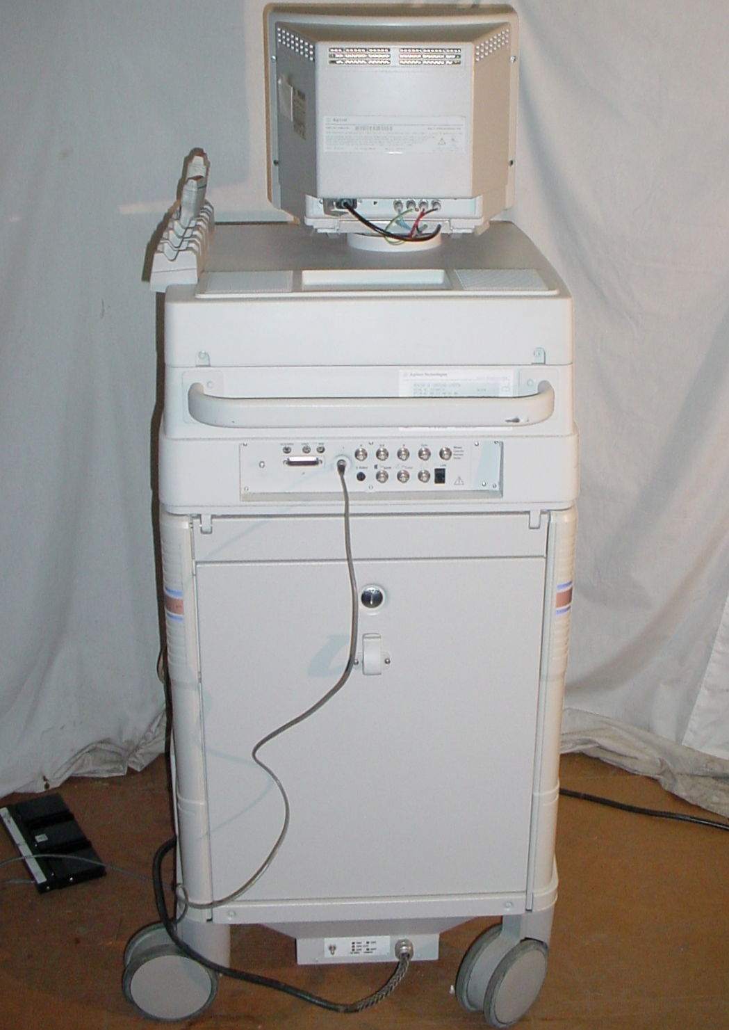 a computer sitting on top of a white cabinet