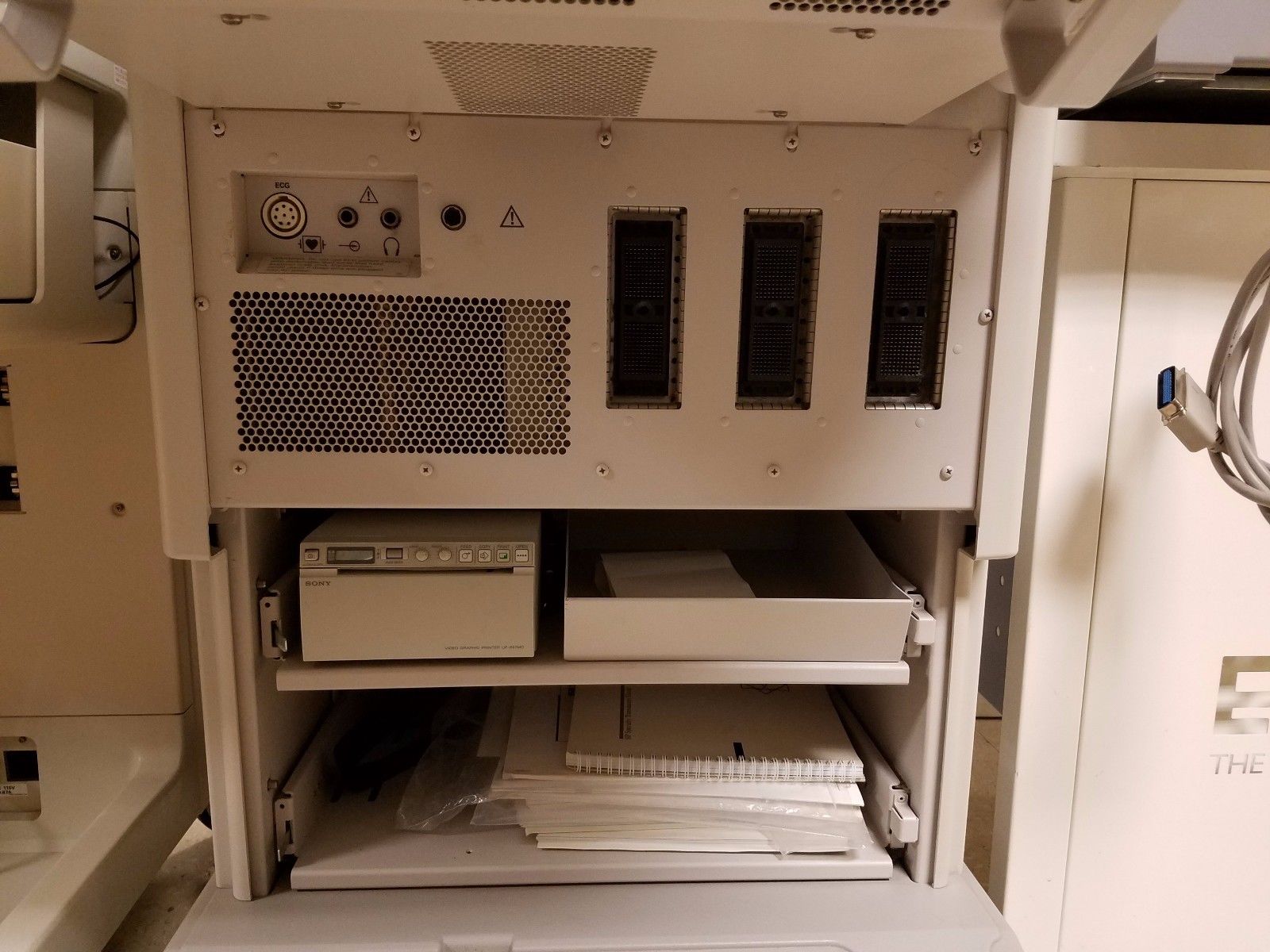 a white cabinet with a bunch of electronics inside of it