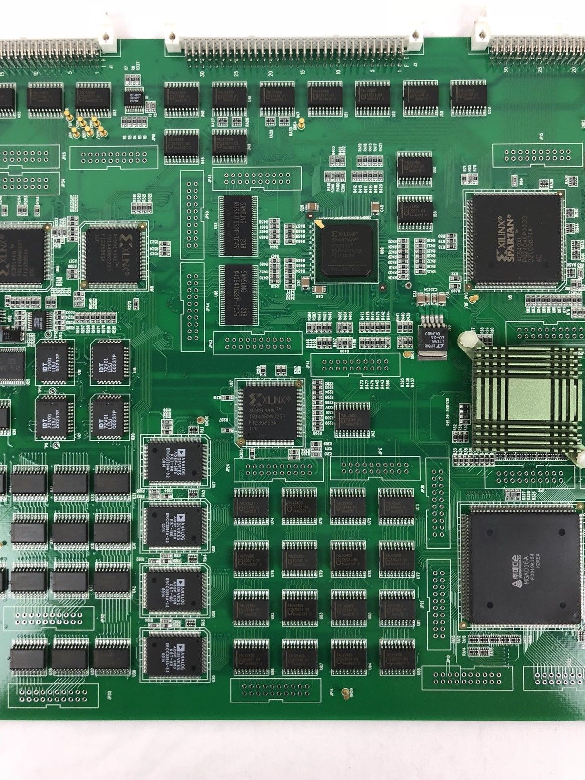 a close up of a green electronic board