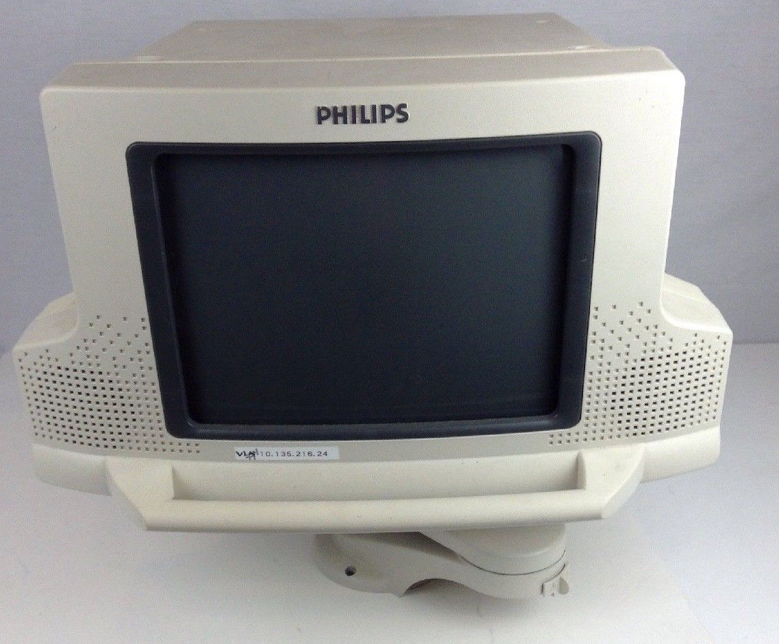 a computer monitor sitting on top of a white table