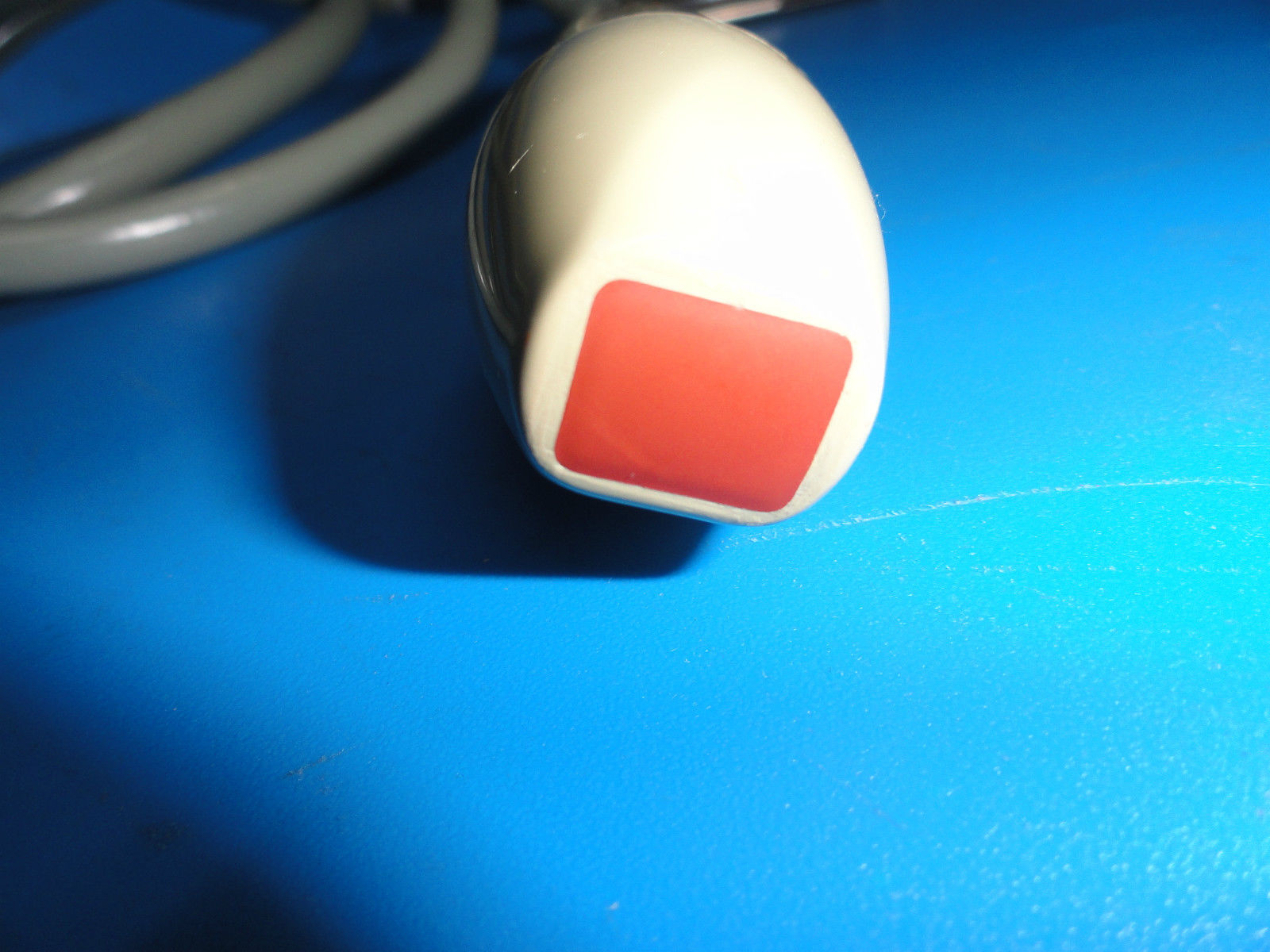 a red and white object sitting on top of a blue surface