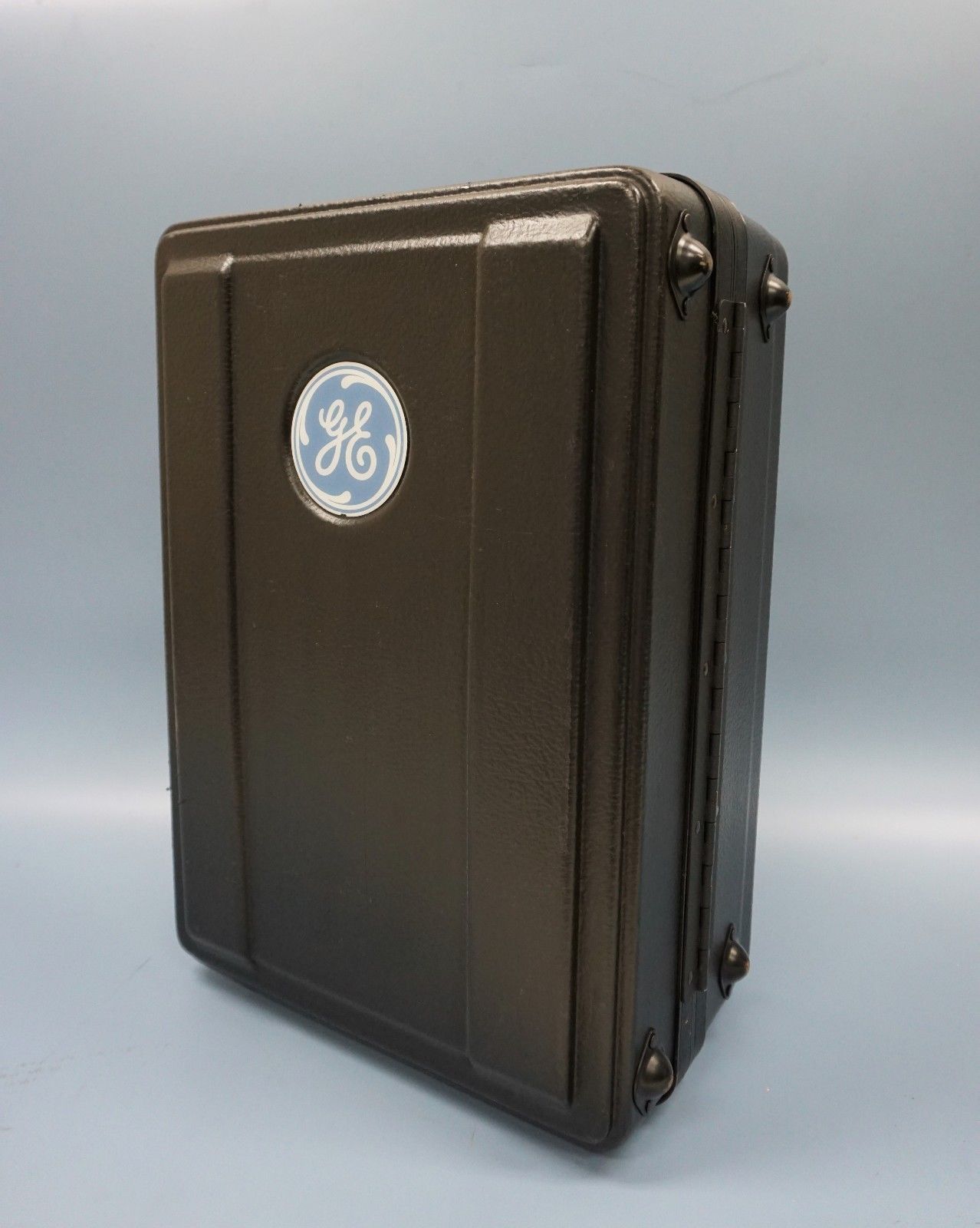 a brown suitcase with a blue and white logo