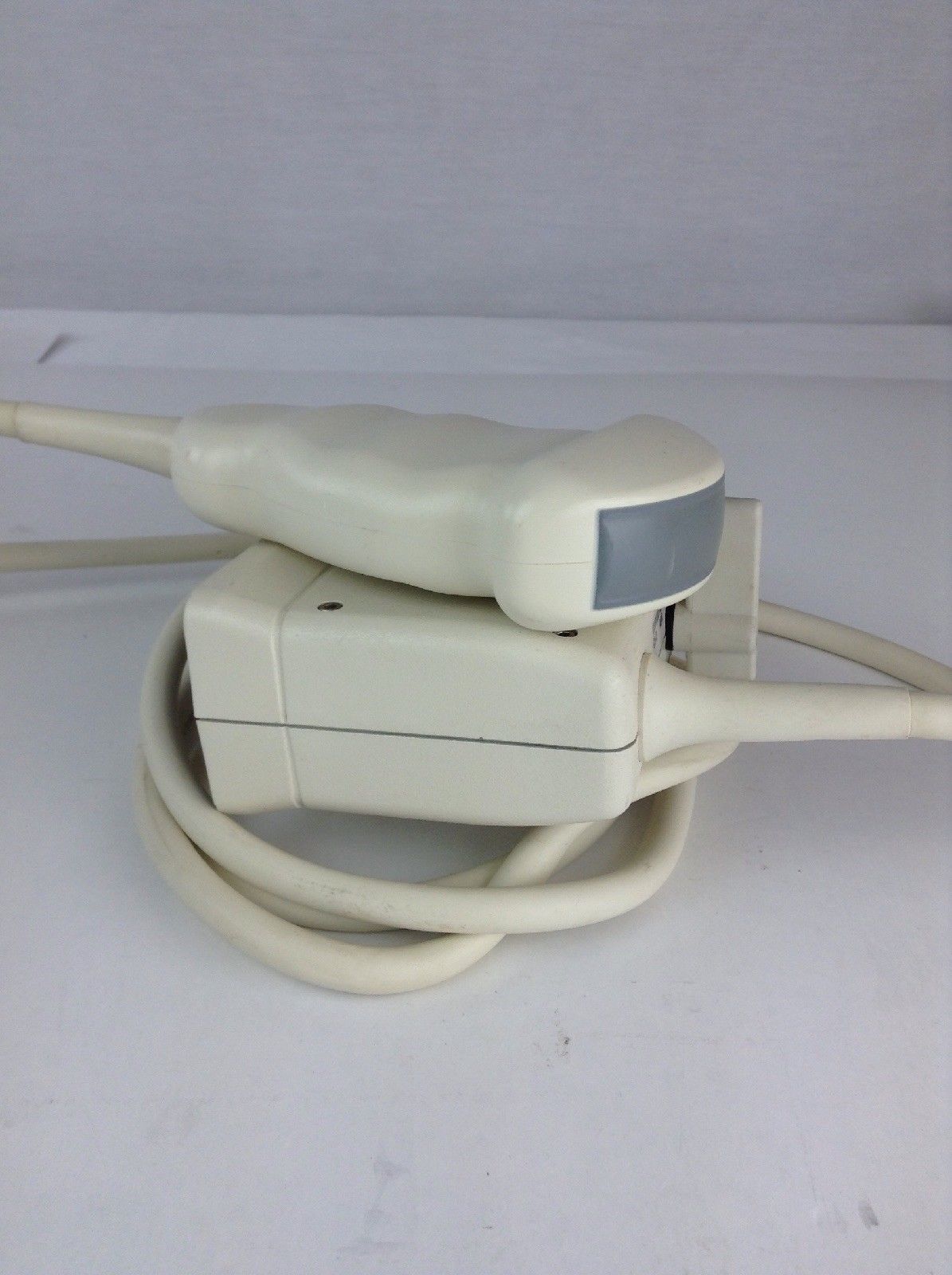 a cord connected to a device on a white surface